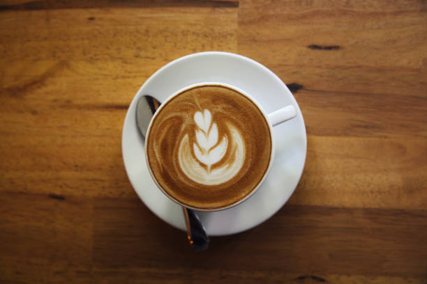 istock cappuccino coffee on wood background 684833888