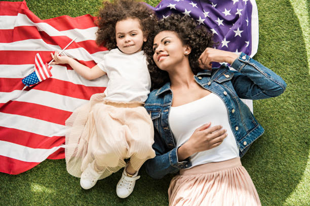 istock woman with daughter on american flag 684834064