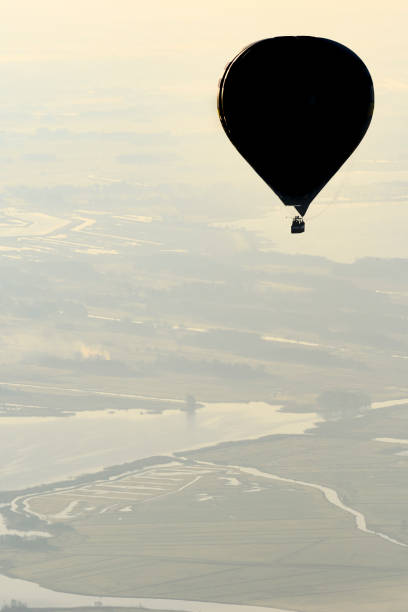 istock Hot air balloon flying in mid air during beautiful morning 684834496