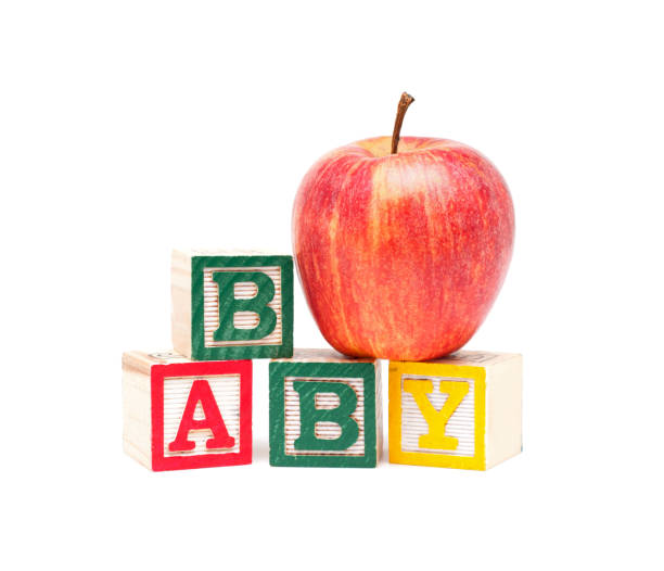 istock Wooden blocks and apple with baby isolated on white background 684834592