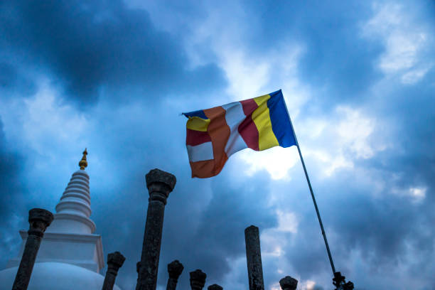 A Stupa, Clouds and a flag, Anuradhapura, Sri Lanka Stormy weather over a stupa in Sri Lanka anuradhapura stock pictures, royalty-free photos & images