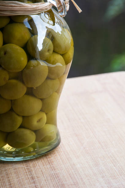 istock Green Spanish olives in glass jar 684837742