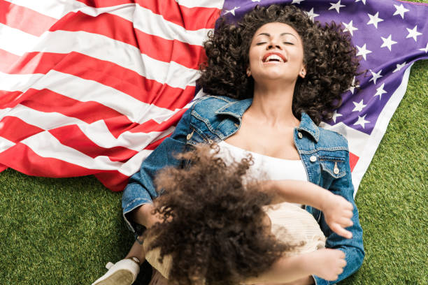 istock woman with daughter on american flag 684838328