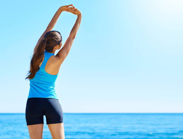 Shot of a young woman stretching before her run