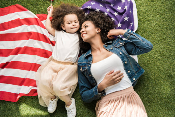 istock woman with daughter on american flag 684840318