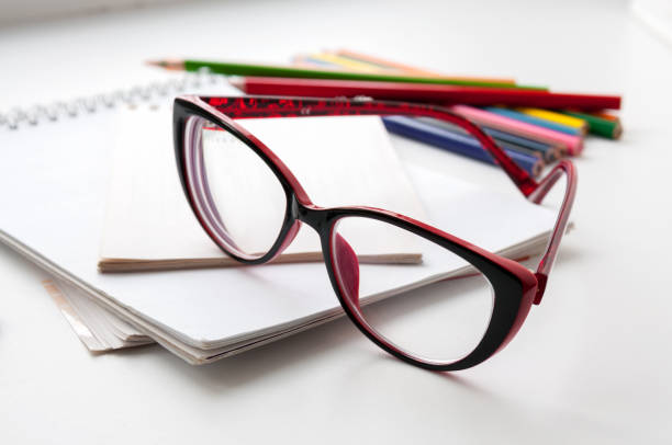 istock Red glasses on the notebook and colored pencils 684841528