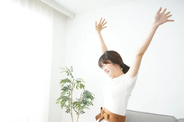 Photo of Young woman stretching her arms
