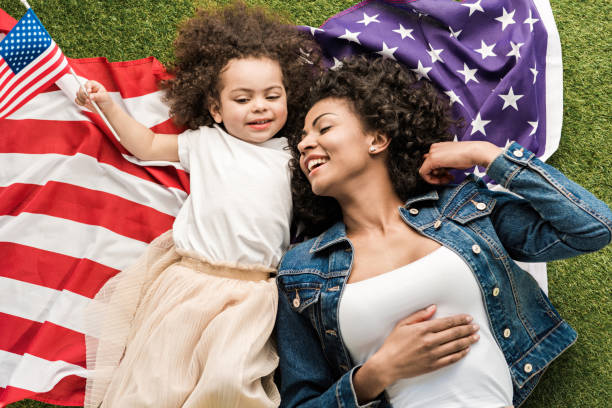 istock woman with daughter on american flag 684848978