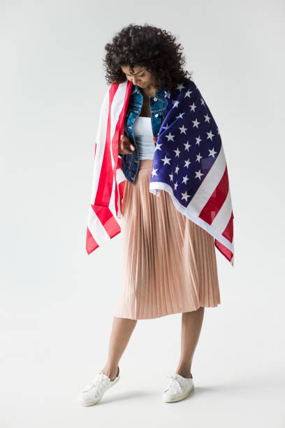 istock woman cowered with american flag 684852158