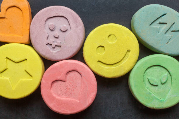 Ecstasy pills Ecstasy tablets on black background ecstasy stock pictures, royalty-free photos & images