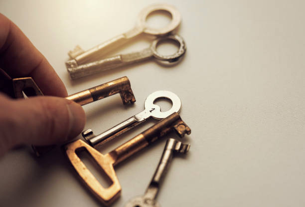istock Man taking an old key, keys on the table 684852898