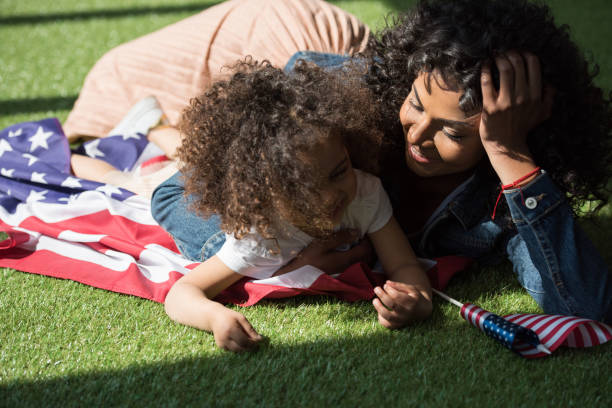istock woman with daughter on american flag 684870394
