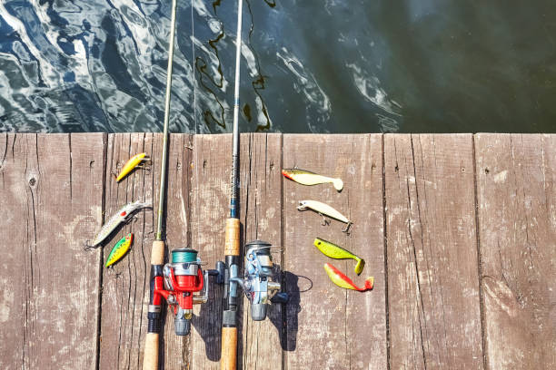 istock Two fishing rods with reels and artificial spinning lures. 684873728