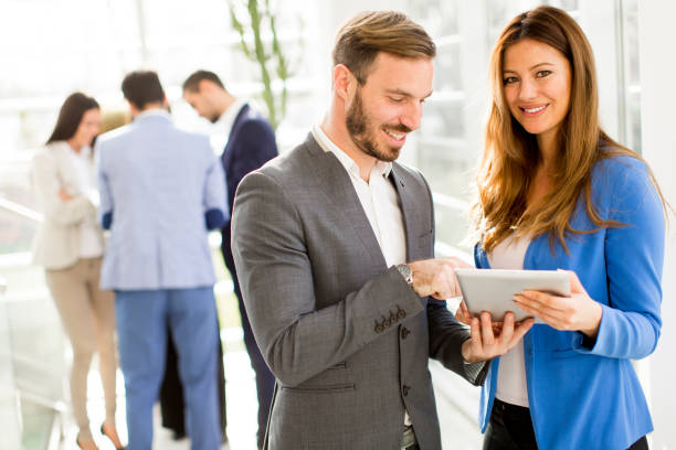 istock Young business couple using tablet in the office 684876412