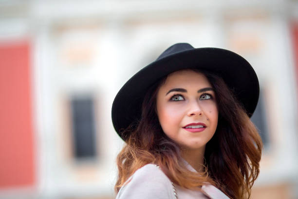 istock The girl in a coat with black hat on head. 684876428