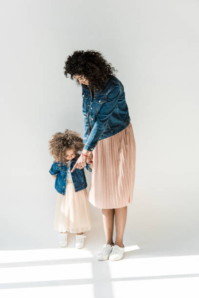 istock mother and daugter holding hands 684877020