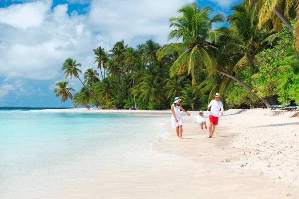 istock family with kid playing on beach 684879750
