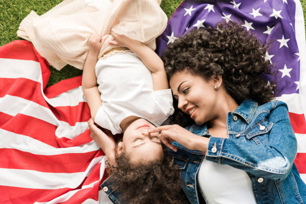 istock woman with daughter on american flag 684883248
