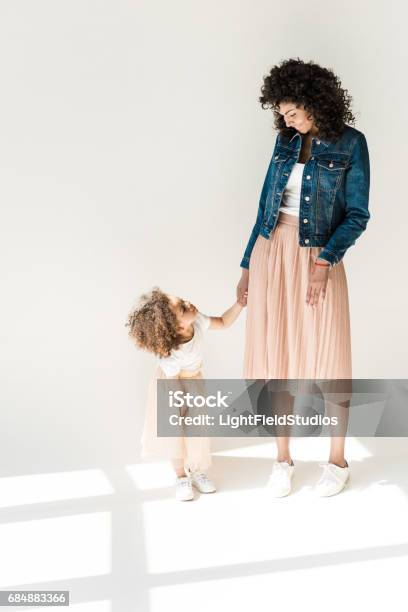 Mother And Daugter Holding Hands Stock Photo - Download Image Now - Studio - Workplace, Walking, Baby Girls