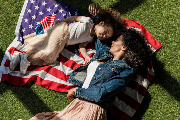 istock woman with daughter on american flag 684883778