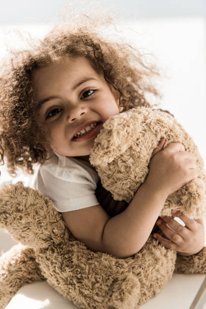 istock baby girl with teddy bear 684886922