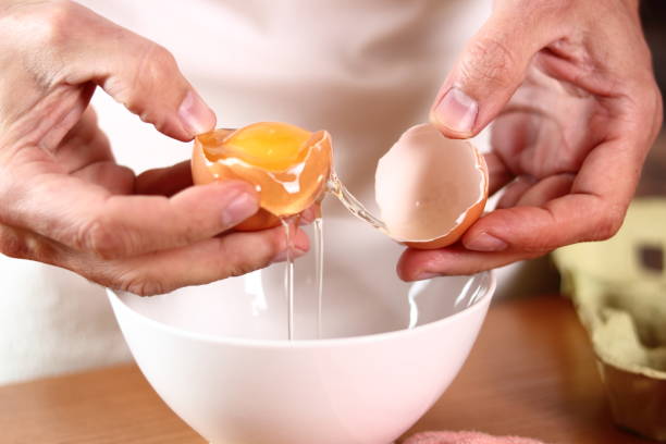 istock Separating egg yolk from white. Making mayonnaise with a wooden spoon. 684893726