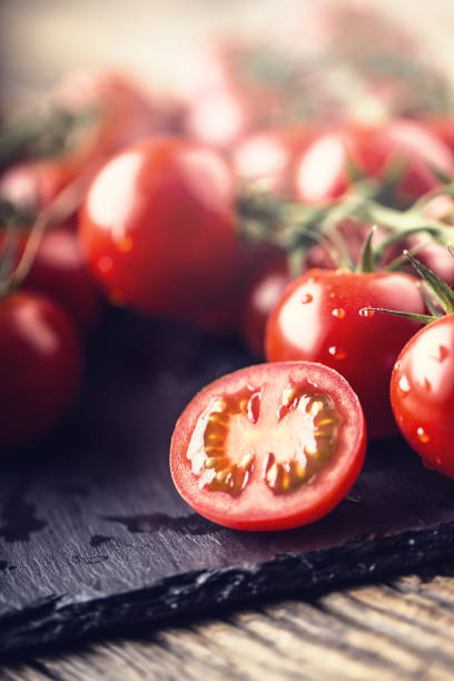 istock Fresh cherry tomatoes. Ripe tomatoes on oak wooden background 684896688