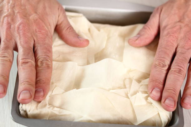 istock Fold pastry over filling. Making Potato and Leek Filo Pie. Series. 684896806