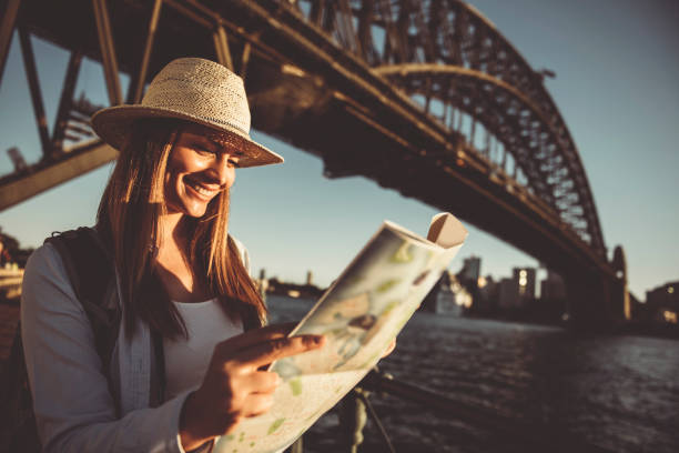 istock Woman traveler holding city map 684896846