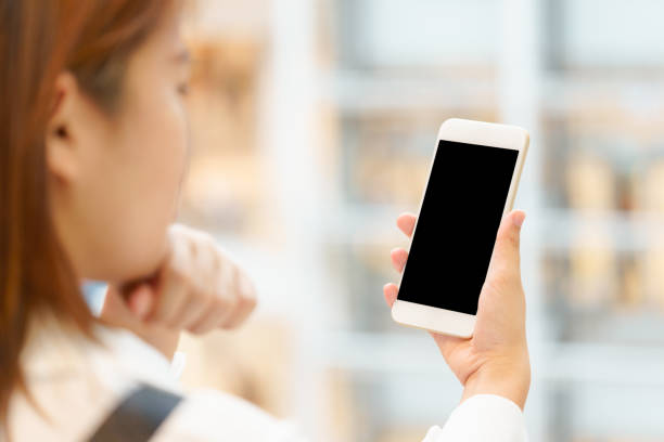 istock Young woman using smart phone with hands on blur background. 684912074