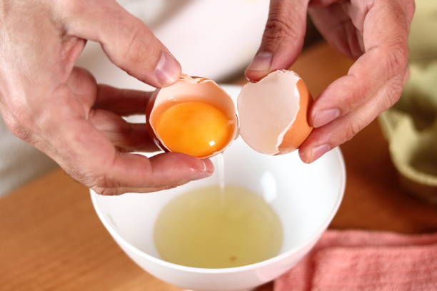 istock Separating egg yolk from white. Making mayonnaise with a wooden spoon. 684918882