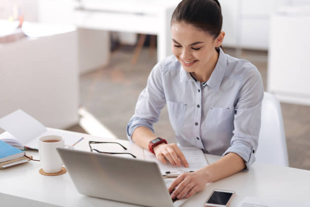 istock Attractive smiling female sitting in office 684925742