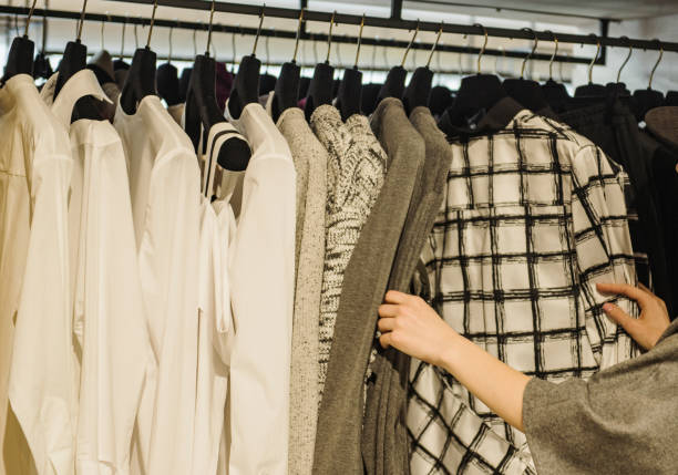 istock Shopping concept: girl in a boutique loonking at clothes. 684932152