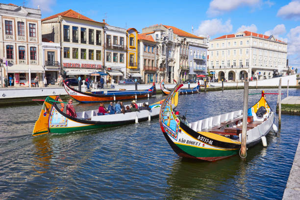 AVEIRO, PORTUGAL - MARCH 21, 2017: The Vouga river with traditio AVEIRO, PORTUGAL - MARCH 21, 2017: The Vouga river with traditional boats, Called Moliceiro, Aveiro, Portugal on March 21, 2017 gondola traditional boat stock pictures, royalty-free photos & images