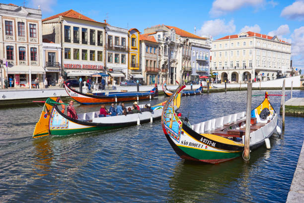 AVEIRO, PORTUGAL - MARCH 21, 2017: The Vouga river with traditio AVEIRO, PORTUGAL - MARCH 21, 2017: The Vouga river with traditional boats, Called Moliceiro, Aveiro, Portugal on March 21, 2017 gondola traditional boat photos stock pictures, royalty-free photos & images