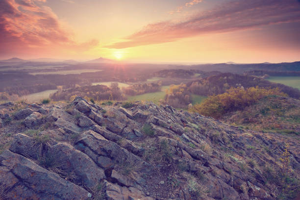 istock Misty valley, sharp rocks gentle cut creamy fog to strips. Long deep valley full of fresh spring mis 684939410