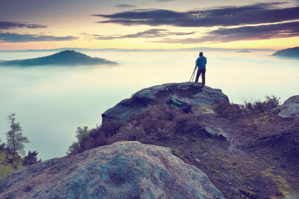 istock Misty valley, sharp rocks gentle cut creamy fog to strips. Long deep valley full of fresh spring mis 684940092