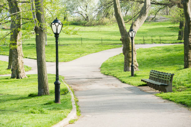 This is a royalty free stock color photograph of a pedestrian zoned sidewalk in Central Park West, an urban travel destination in New York City, USA. Photographed from a high angle view and a wide angle with a Nikon D800 DSLR in spring.