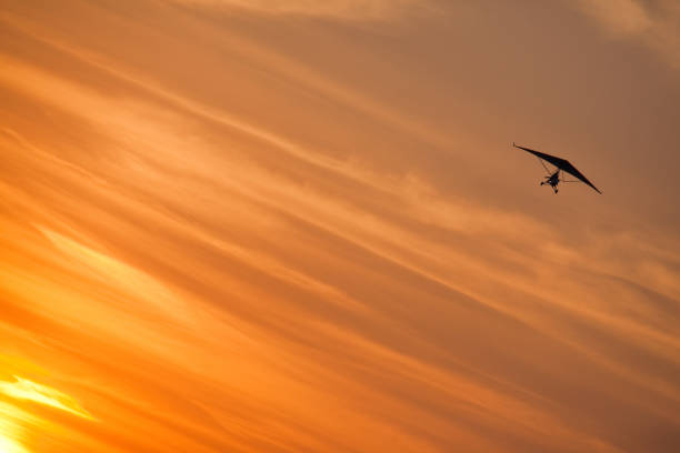 Sunset hang gliding stock photo