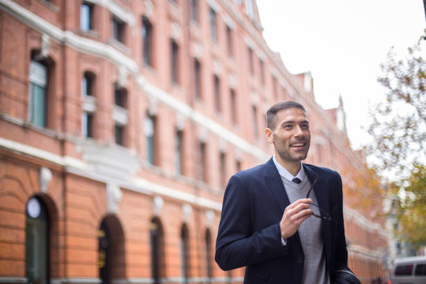 istock Smiling businessman on the street 684947830