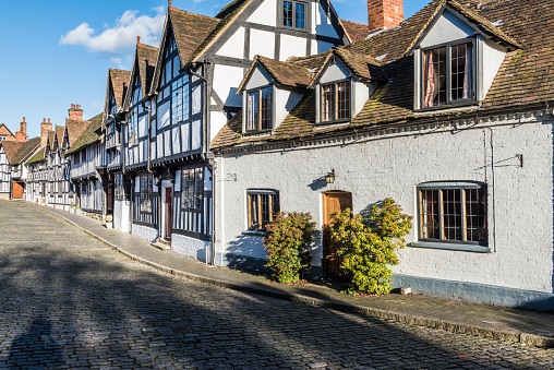 Old houses and facades in tudor style in a street in England, Uk