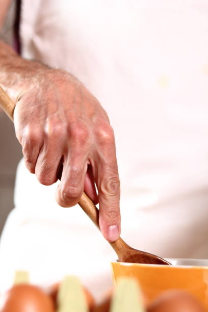istock Whisking emulsion. Making mayonnaise with a wooden spoon. 684957740