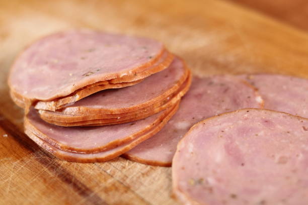 istock Sausage slices on wooden cutting board 684958506