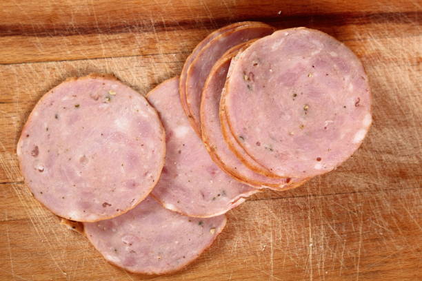 istock Sausage slices on wooden cutting board 684959432