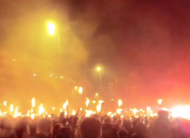 Crowd holding totches at Golden Dawn political party protest in Athens