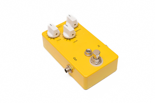 Yellow Guitar Pedal Isolated On White Surface