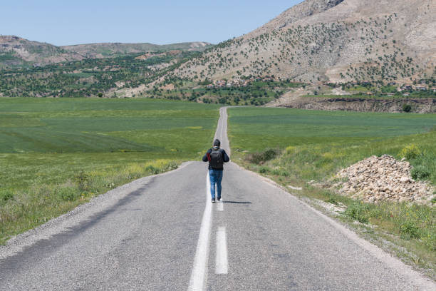 Lonely man walking in Asphalt road in Turkey, Anatolian