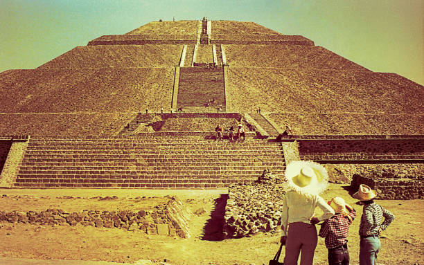 Vintage image of the Pyramid of the Sun, Mexico Vintage yelow toned image of a family looking at the The Pyramid of the Sun in Teotihuacan during a trip to Mexico mexico state photos stock pictures, royalty-free photos & images