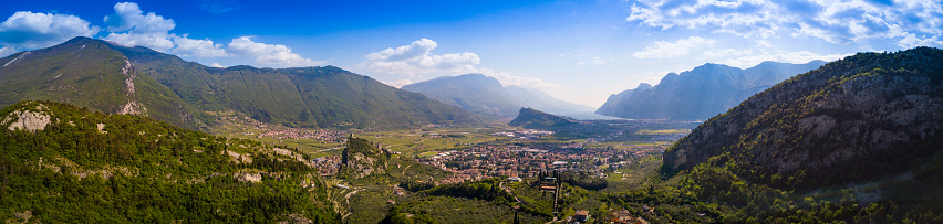 Aerial view of Arco on the lake valley and the garda lake on the background