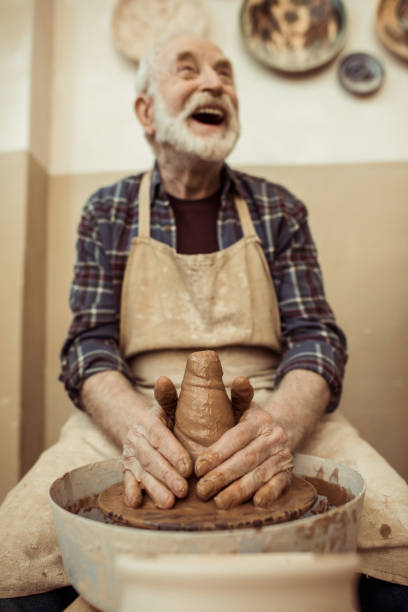 istock Front view of male craftsman working on potters wheel 684990400